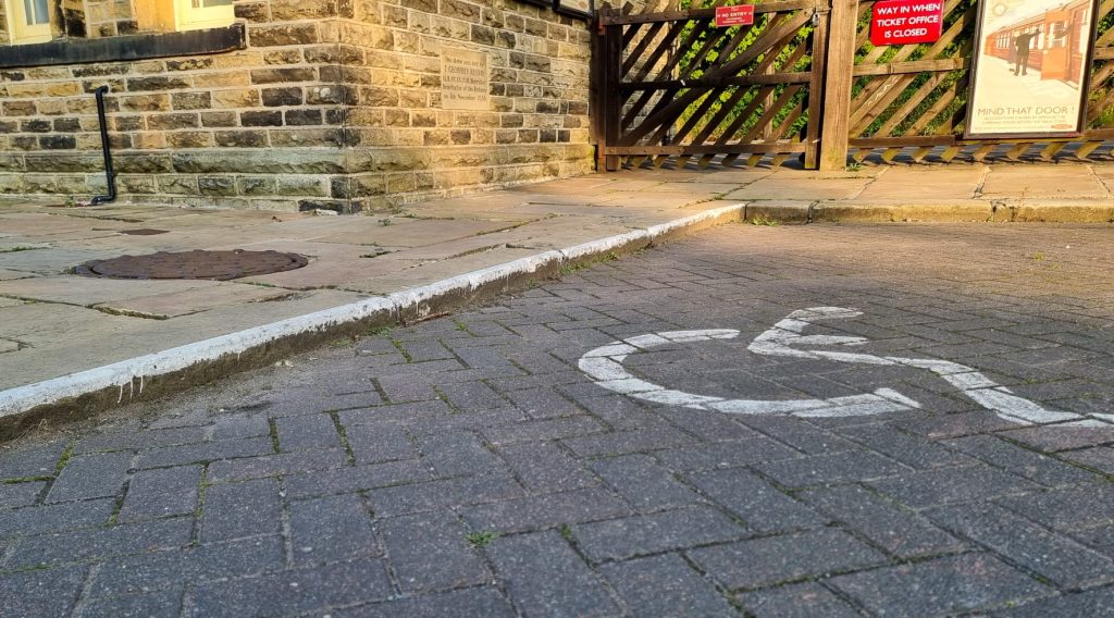 Image shows the curb drop located next to the disabled parking bay. The drop measures around 3.5 inches.