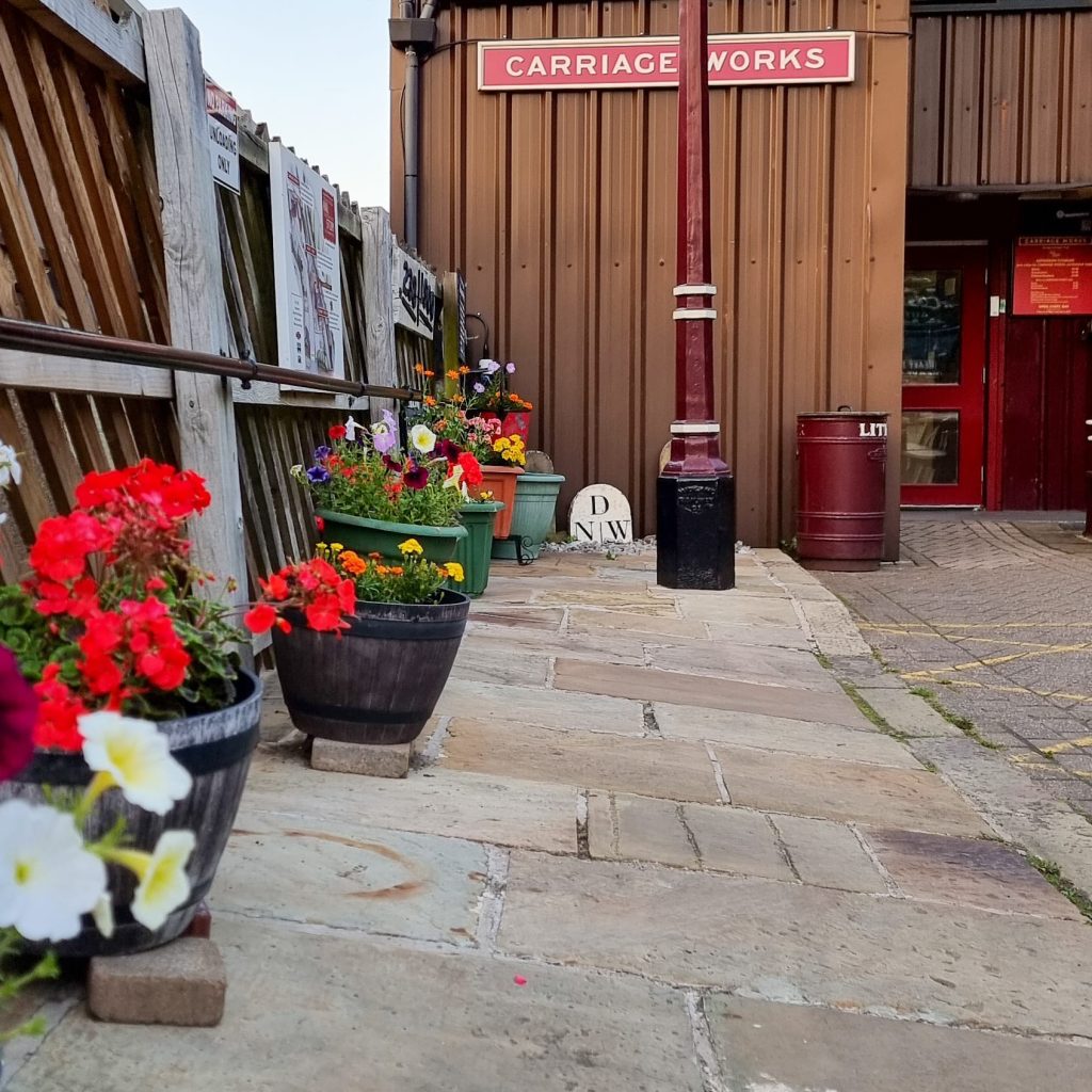 Image shows the stone path leading to VCT. Including the dropped curb near the disabled parking bays.